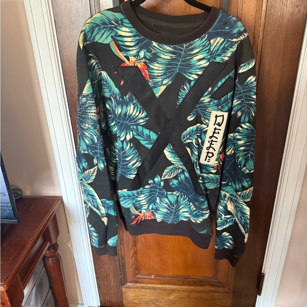 10.Deep Black Tropical Leaf Crewneck Sweater with Teal Accents